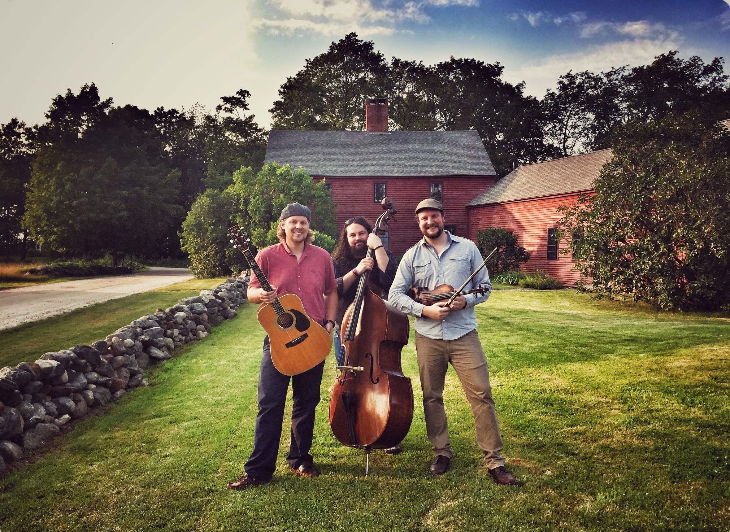 Musicians with instruments outside the Blasty Bough farmhouse